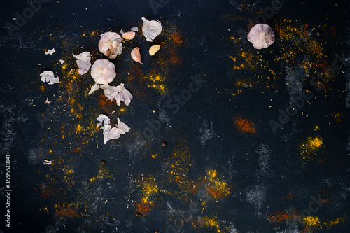 space dark background of colorful spices and garlic