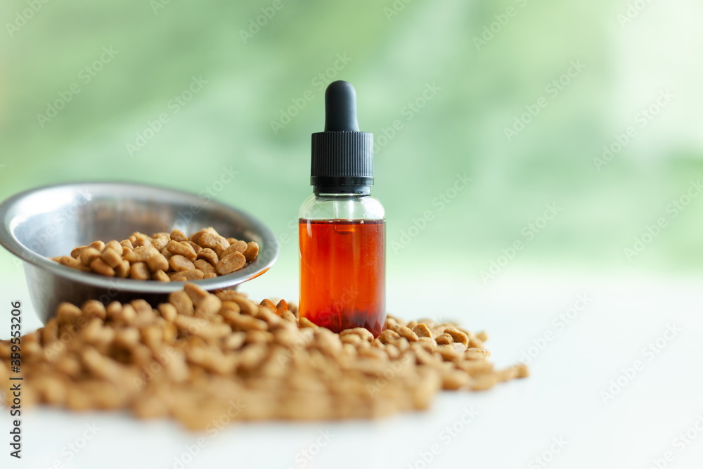 metal bowl with animal feed and a jar of CBD oil metal bowl with animal feed and a jar of CBD oil