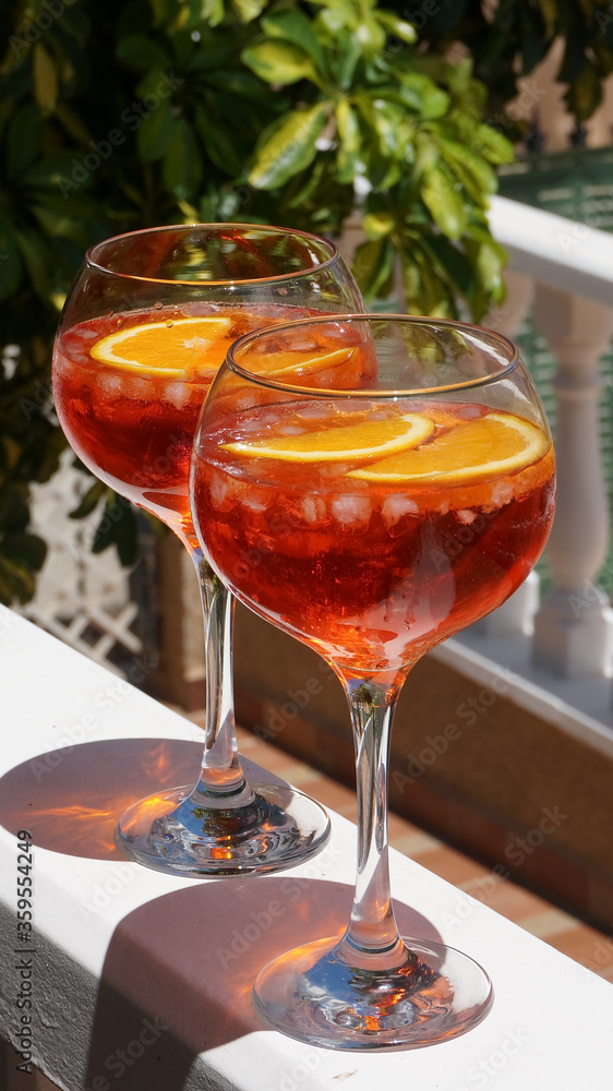 Aperol spritz in big glasses red summer cocktail, terrace party. High quality photo Aperol spritz in big glasses red summer cocktail, terrace party. High quality photo