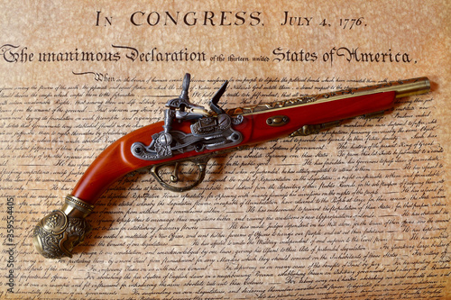 Declaration of Independence with a period flintlock pistol
