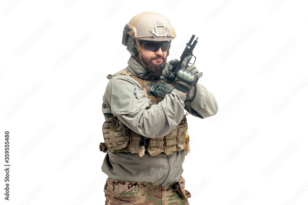 American ranger in military equipment with a gun and knife on a white background, portrait of a special forces soldier with a weapon