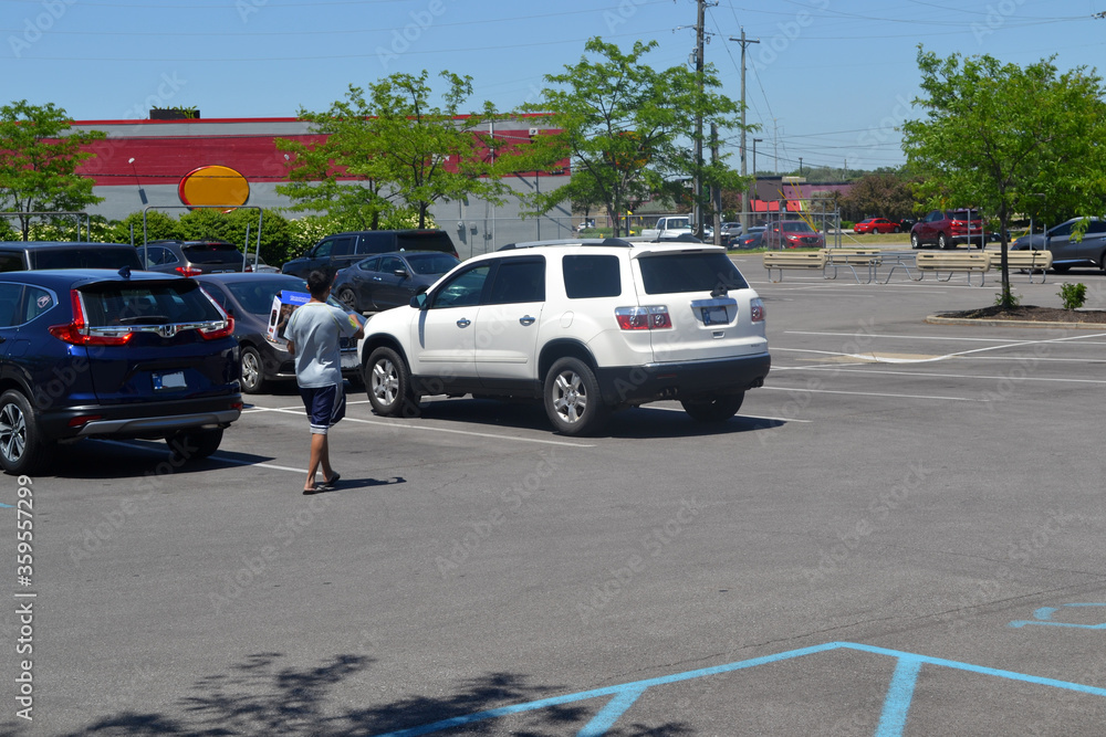 Man Walking to His Vehicle In a Parking Lot