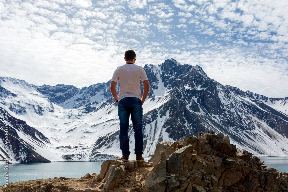 a man is standing on the top of the mountain