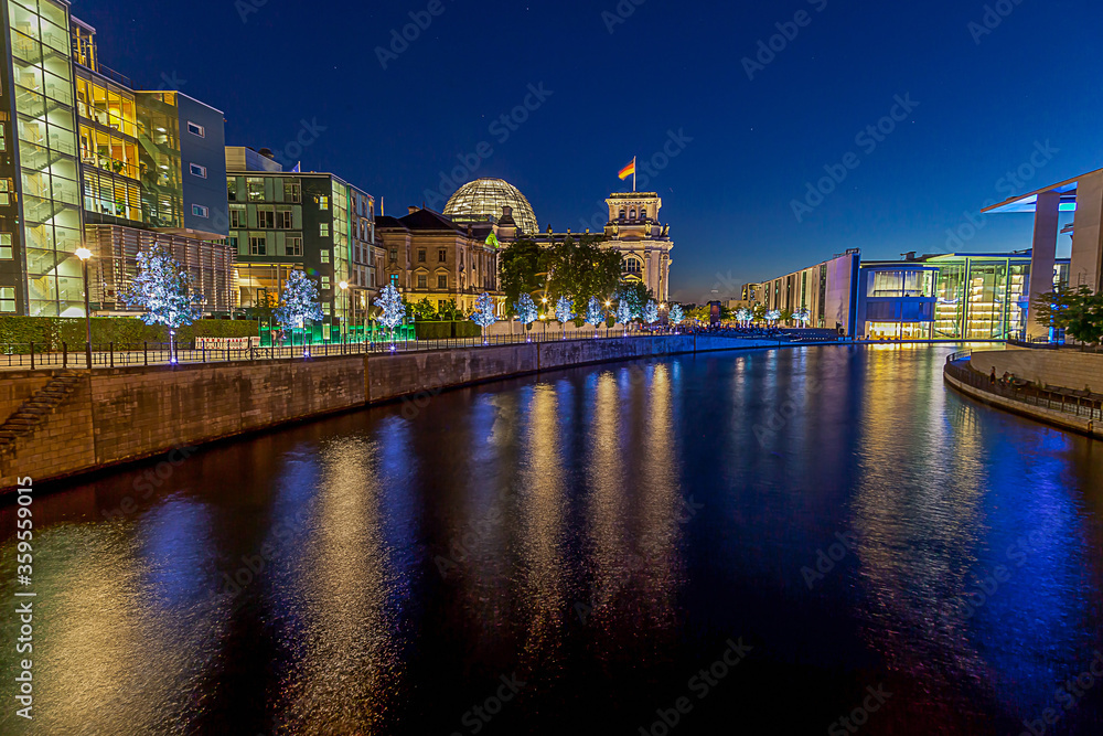 View on illuminated Reichstag building in Berlin during evening twillight in summer