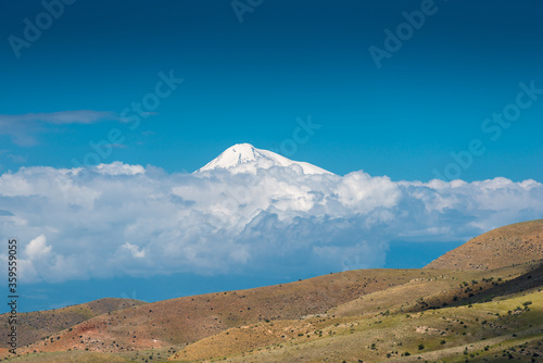 High snowy mountain Ararat behind the clouds on a sunny day  beautiful landscape of Armenia
