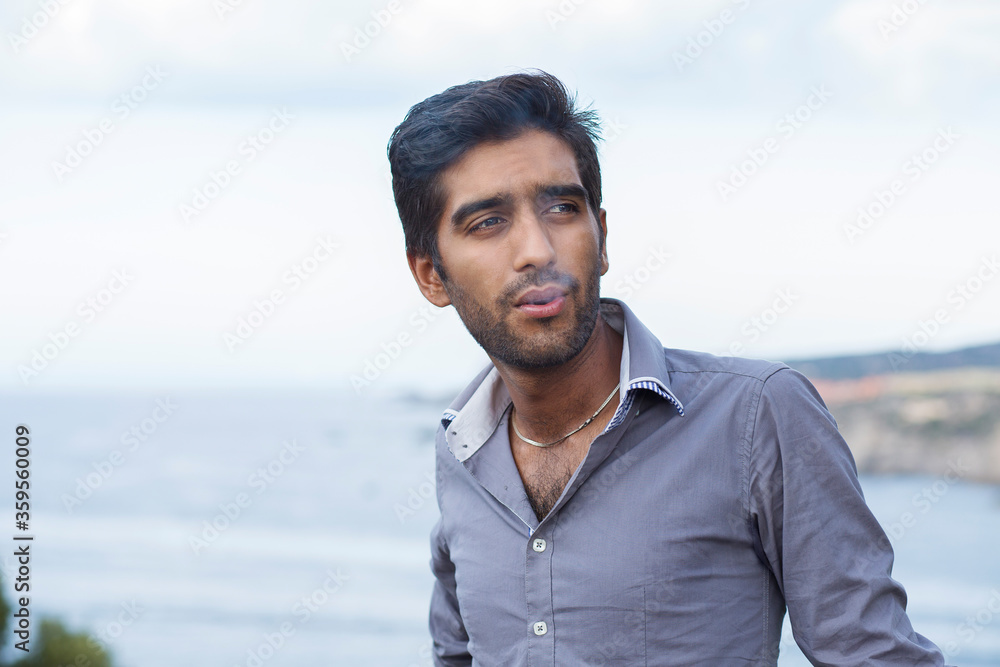 Happy ethnic man smoking cigarette, smiling, thinking Happy ethnic man smoking cigarette, smiling, thinking