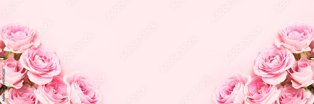 Fototapeta premium Holiday banner. Bouquets of pink roses on pink background. Mother's day, Valentines Day, Birthday celebration concept. Greeting card. Copy space, top view