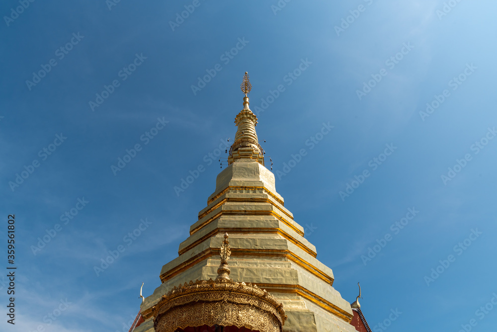 Fototapeta premium The golden pagoda with blue sky background.