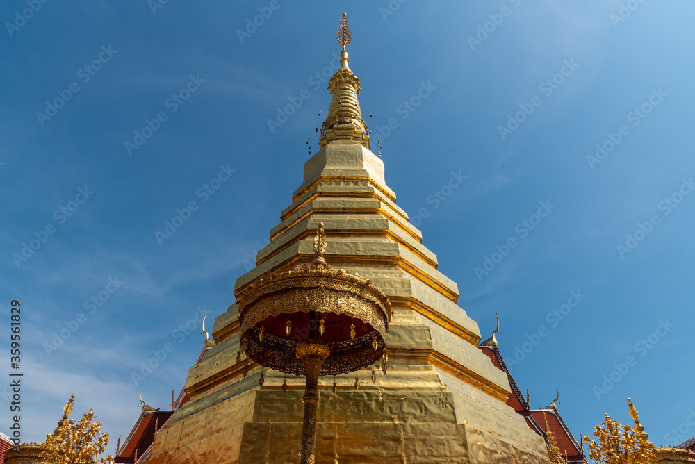 Fototapeta premium The golden pagoda with blue sky background.