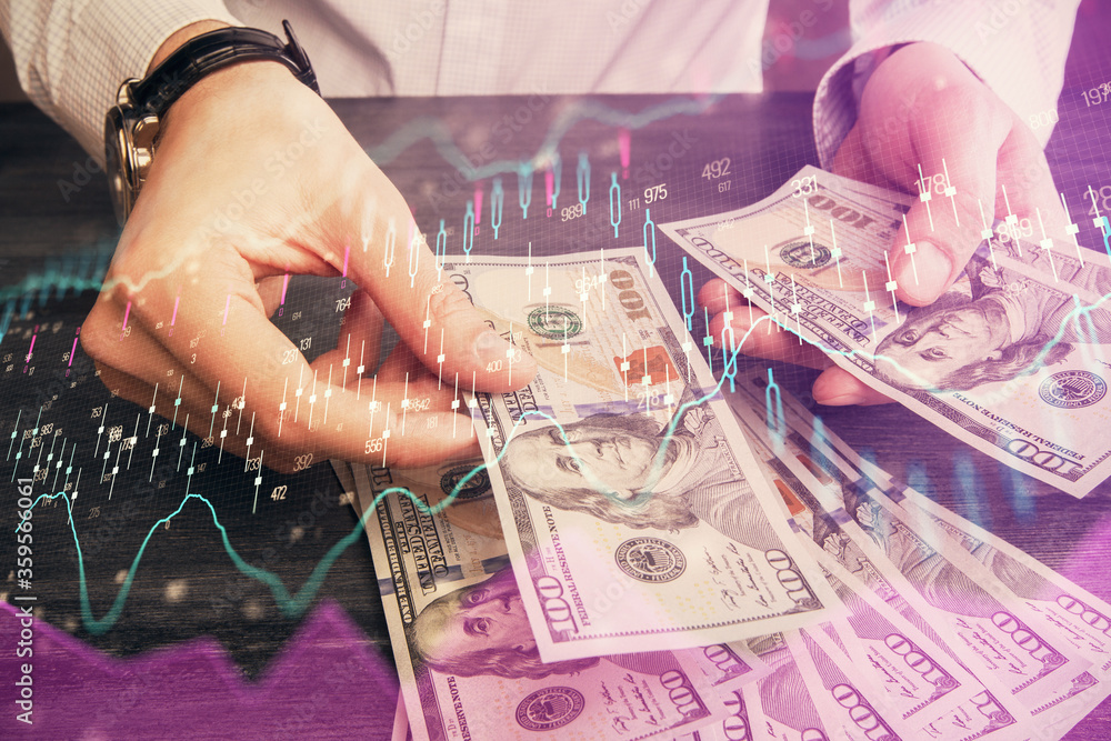 Multi exposure of financial graph drawing hologram and USA dollars bills and man hands. Analysis concept.