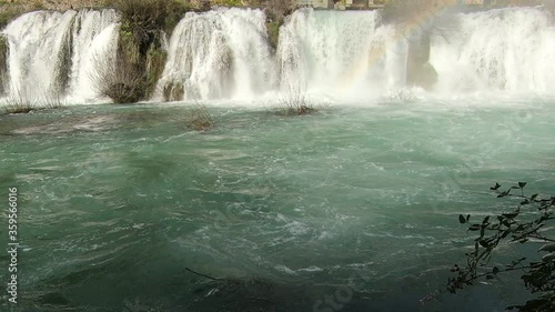 the emerald color of the water and the murmur of a powerful waterfall instantly clear your mind photo