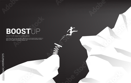 Silhouette of businessman jump over the gap with springboard. Concept of boost and growth in business.