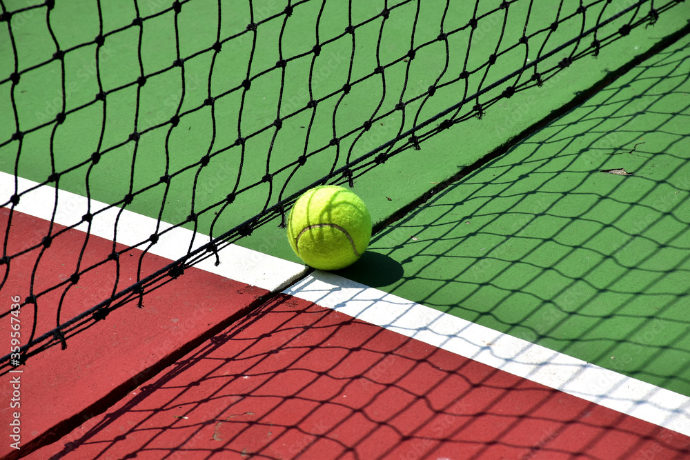 Closeup of Tennis Racket and balls on Tennis Courts in the outdoors. Closeup of Tennis Racket and balls on Tennis Courts in the outdoors.