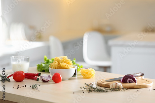 Fresh products and cutting board on kitchen table. Cooking healthy food