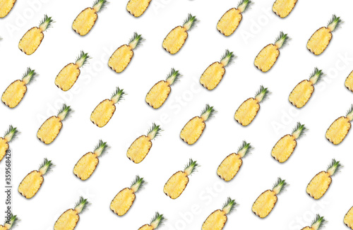 Pattern of pineapple halves on white background