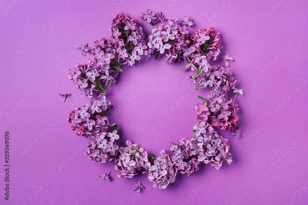 Frame made with beautiful lilac blossom on purple background, flat lay. Space for text