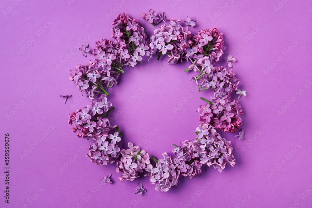 Frame made with beautiful lilac blossom on purple background, flat lay. Space for text Frame made with beautiful lilac blossom on purple background, flat lay. Space for text