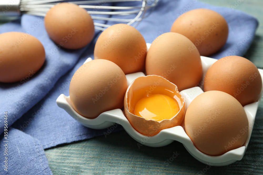 Raw chicken eggs on blue wooden table, closeup Raw chicken eggs on blue wooden table, closeup