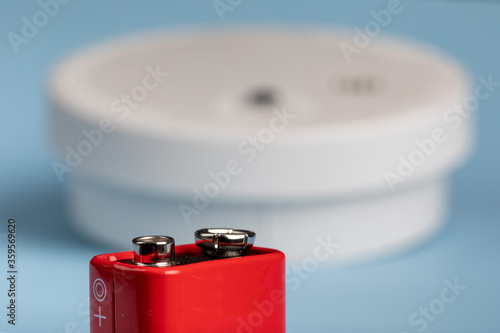 Obraz na plátně a red nine volt battery with a home fire detector in the background