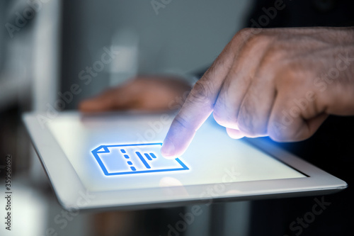Man clicking on document icon using tablet  closeup