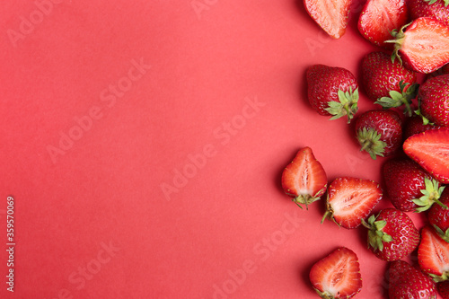 Tasty ripe strawberries on red background, flat lay. Space for text