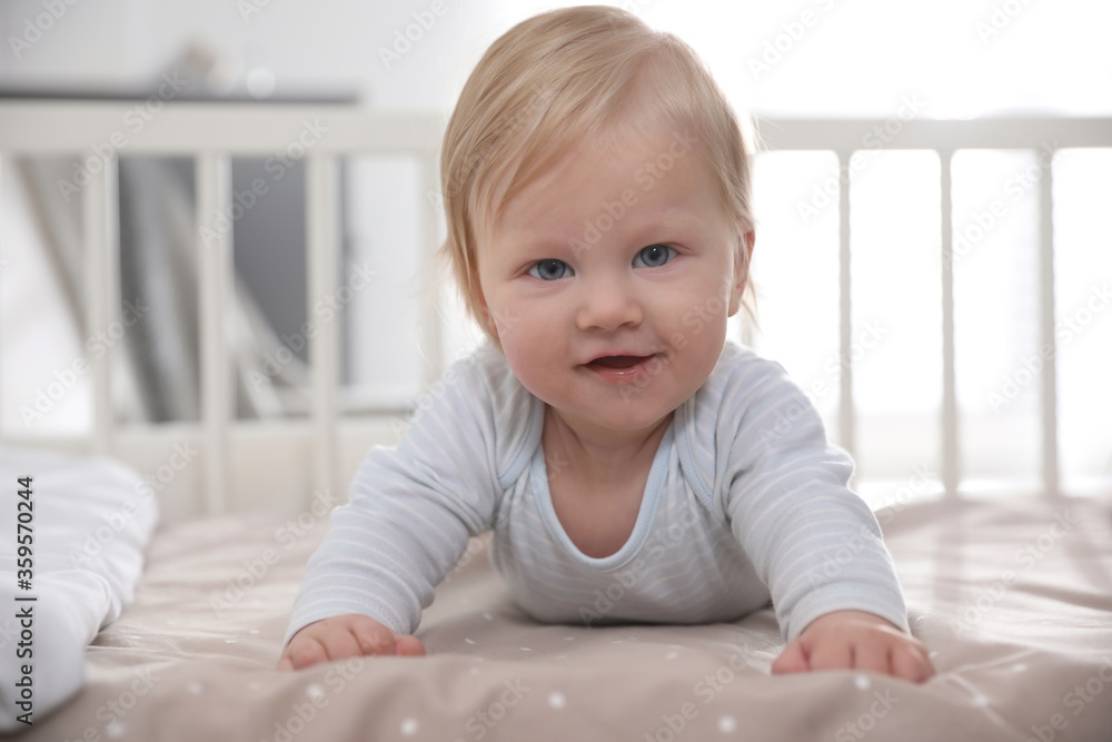 Fototapeta premium Adorable little baby lying in comfortable crib