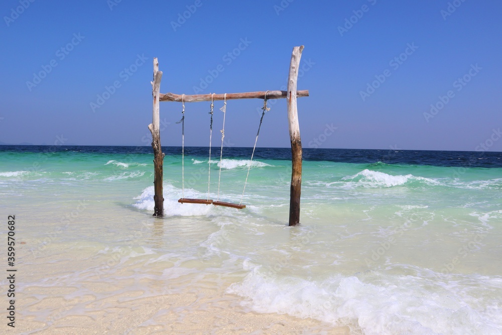 Beautiful beach. Tranquil scenery, relaxing beach, tropical landscape design. Sali Island, Myanmar. Maldives Of Myanmar. Beach with wooden swings. Twigs with a white rope swing on the beach. holiday. Beautiful beach. Tranquil scenery, relaxing beach, tropical landscape design. Sali Island, Myanmar. Maldives Of Myanmar. Beach with wooden swings. Twigs with a white rope swing on the beach. holiday.