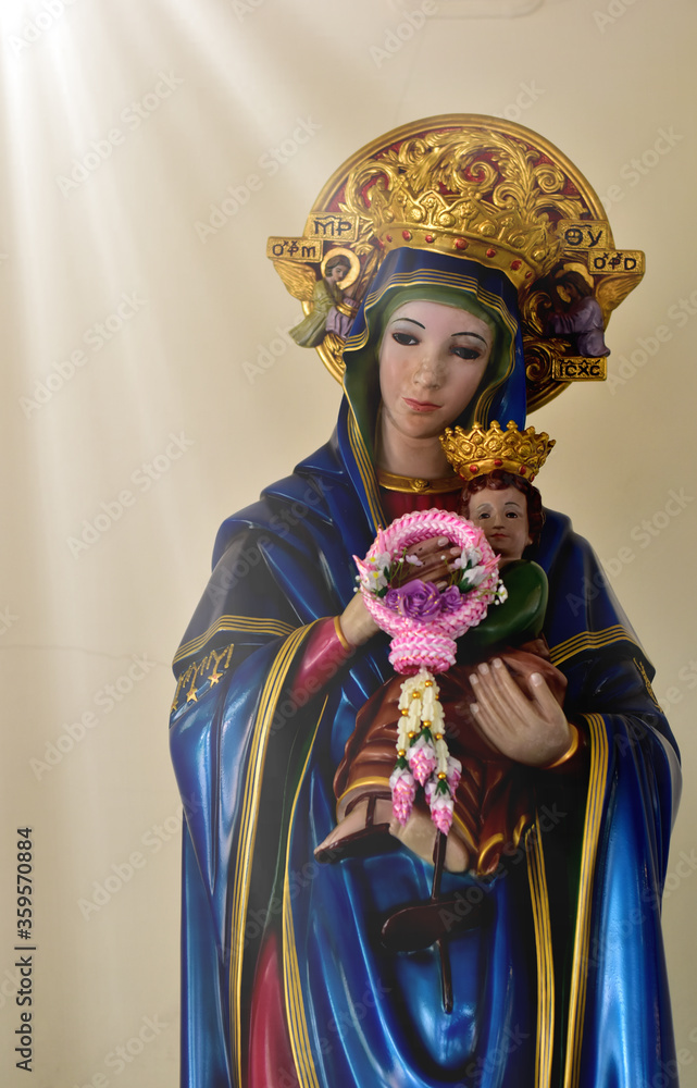 Closeup of Our lady of perpetual help statue virgin Mary with Child Jesus in the church, Thailand. selective focus.