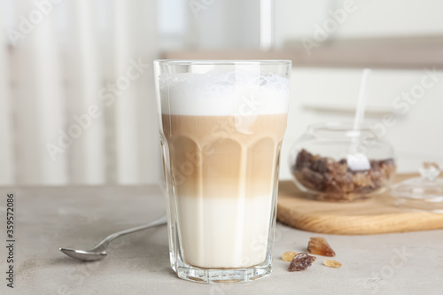 Delicious latte macchiato in glass on grey table indoors photo