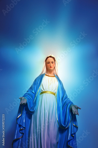 Wallpaper Mural Statue of Our lady of grace virgin Mary view with blurred bright blue background in the church, Thailand. selective focus. Torontodigital.ca