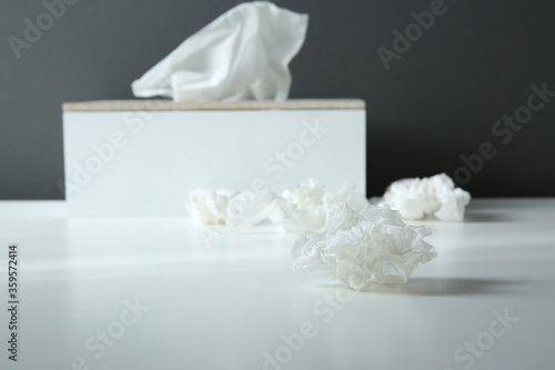 Used paper tissue and holder on white table, closeup
