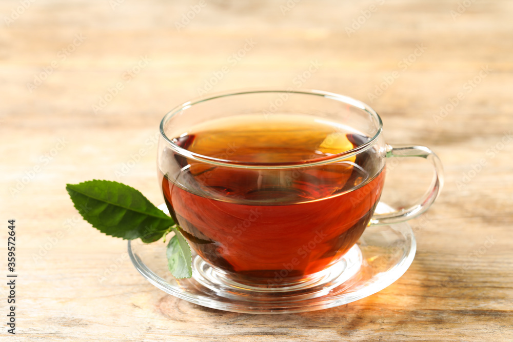 Cup of black tea on wooden table Cup of black tea on wooden table