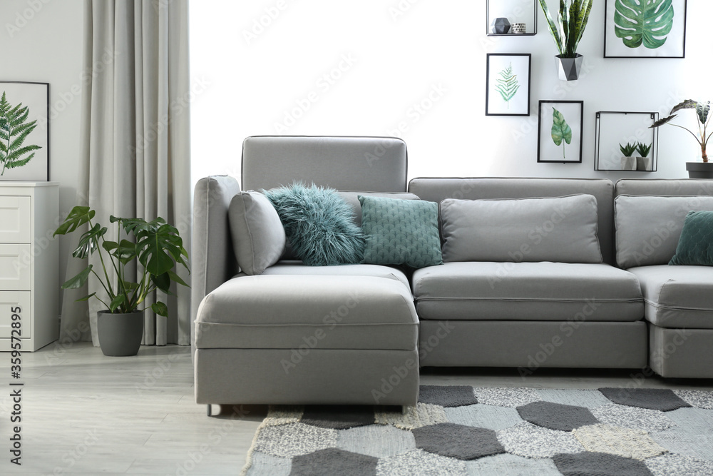 Fototapeta premium Comfortable large sofa in light room. Interior design