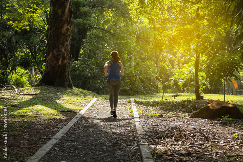 woman exercising in the park alone in the middle of nature