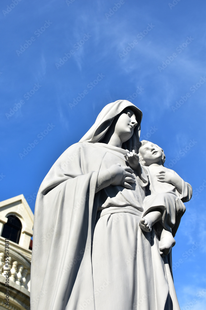 Fototapeta premium Statue of Our lady and child Jesus in catholic church, Thailand. selective focus.