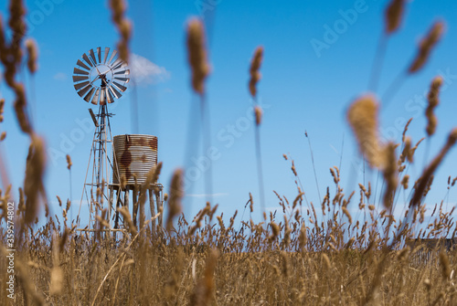 Windmill in empty farm field in outback Australia.