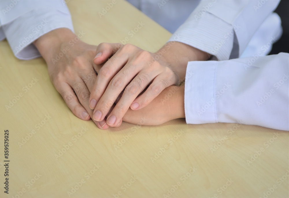 close up of a doctor holding a patient close up of a doctor holding a patient