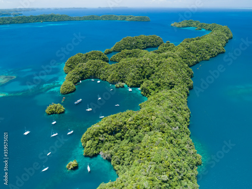 Fototapeta Naklejka Na Ścianę i Meble -  Aerial shot of Palau islands with sailing boats anchored in bay