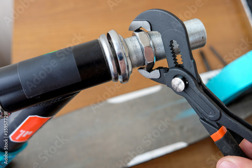 unscrew the nut with an adjustable wrench. repair of household items at home