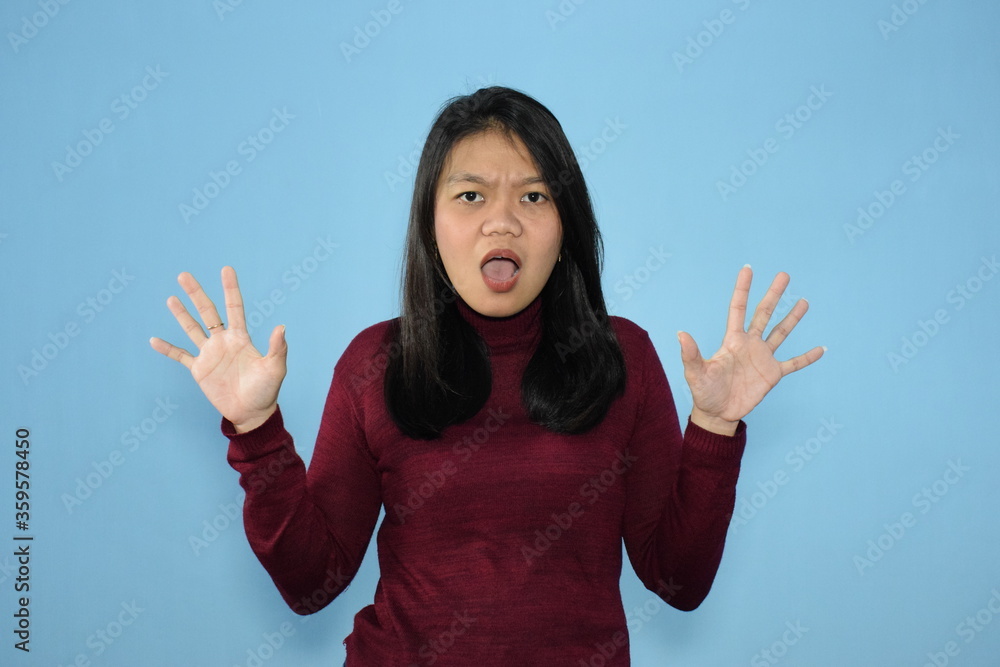 Portrait of Indonesian Woman Wearing Red Shirt And Posing With Isolated Background Portrait of Indonesian Woman Wearing Red Shirt And Posing With Isolated Background