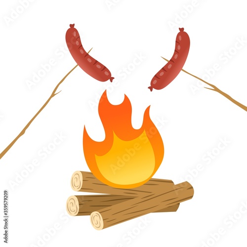 grilling two sausages on campfire
