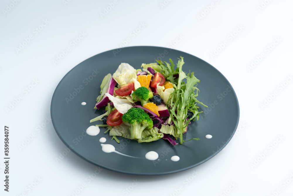 A plate of delicious and healthy green vegetable salad. A plate of delicious and healthy green vegetable salad.
