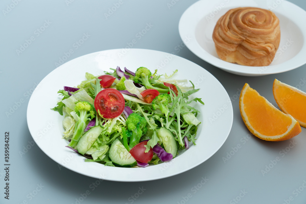 A plate of healthy and delicious salad and a bread A plate of healthy and delicious salad and a bread