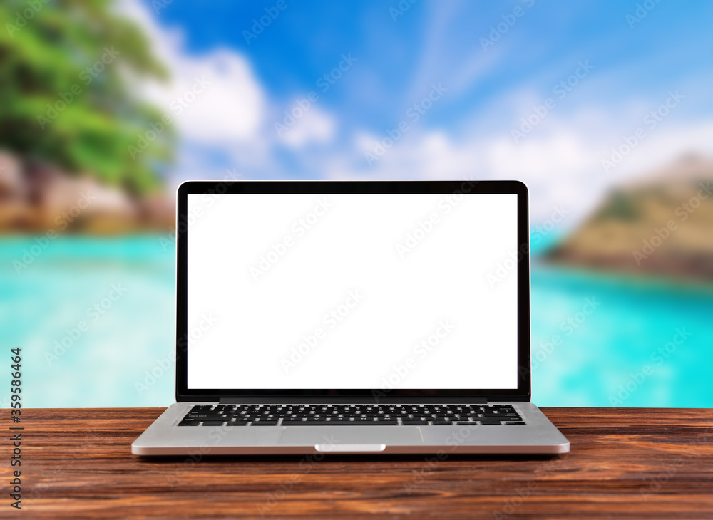laptop computer wood workspace and the beach background
