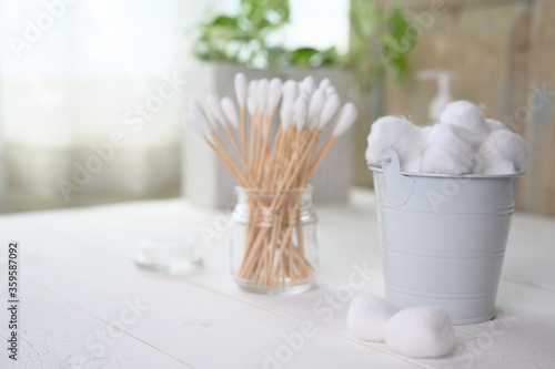 White cotton swabs cotton bud and cotton ball on background