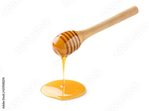 Pure Honey dripping from honey dipper isolated on a white background. clipping path.