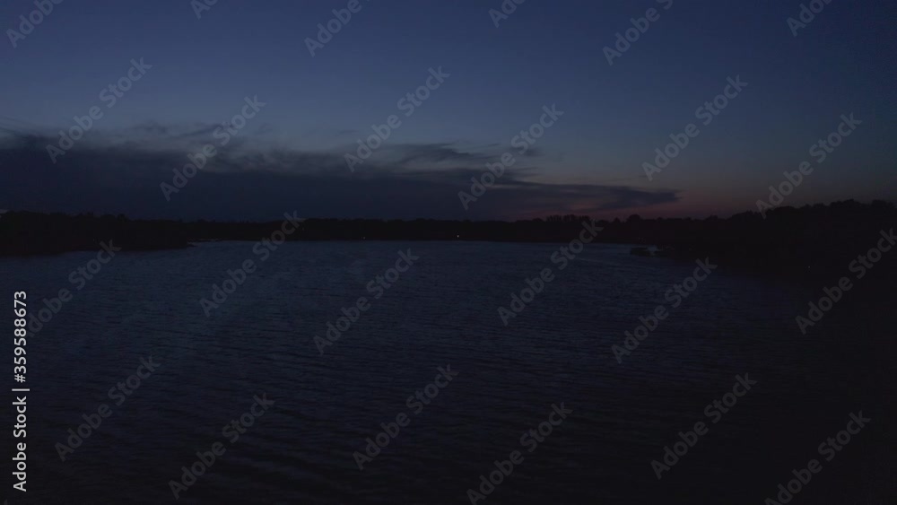 Rising aerial wide shot of a Midwestern lake during twilight. 4K Rising aerial wide shot of a Midwestern lake during twilight. 4K