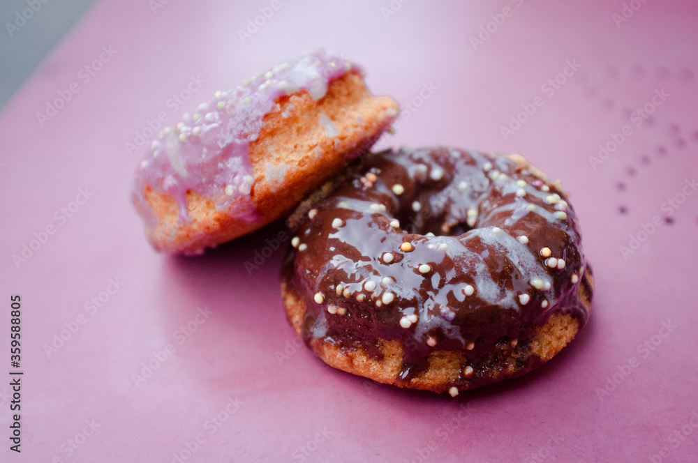 baked vegan gluten free chocolate and strawberry donuts doughnuts on a pink antique table
