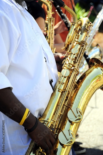 Baritone sax player in concert outdoors.