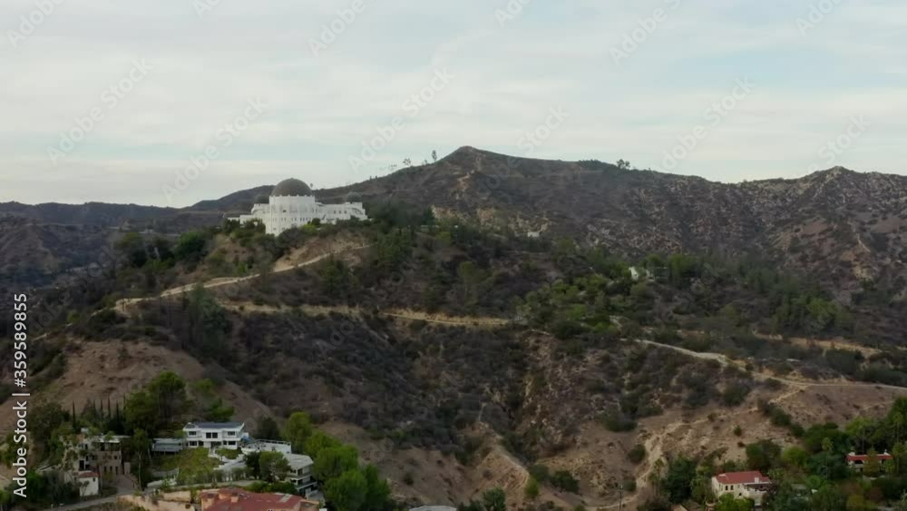 AERIAL: Griffith Observatory with flight over Hollywood Hills in Daylight, Los Angeles, California, Cloudy AERIAL: Griffith Observatory with flight over Hollywood Hills in Daylight, Los Angeles, California, Cloudy